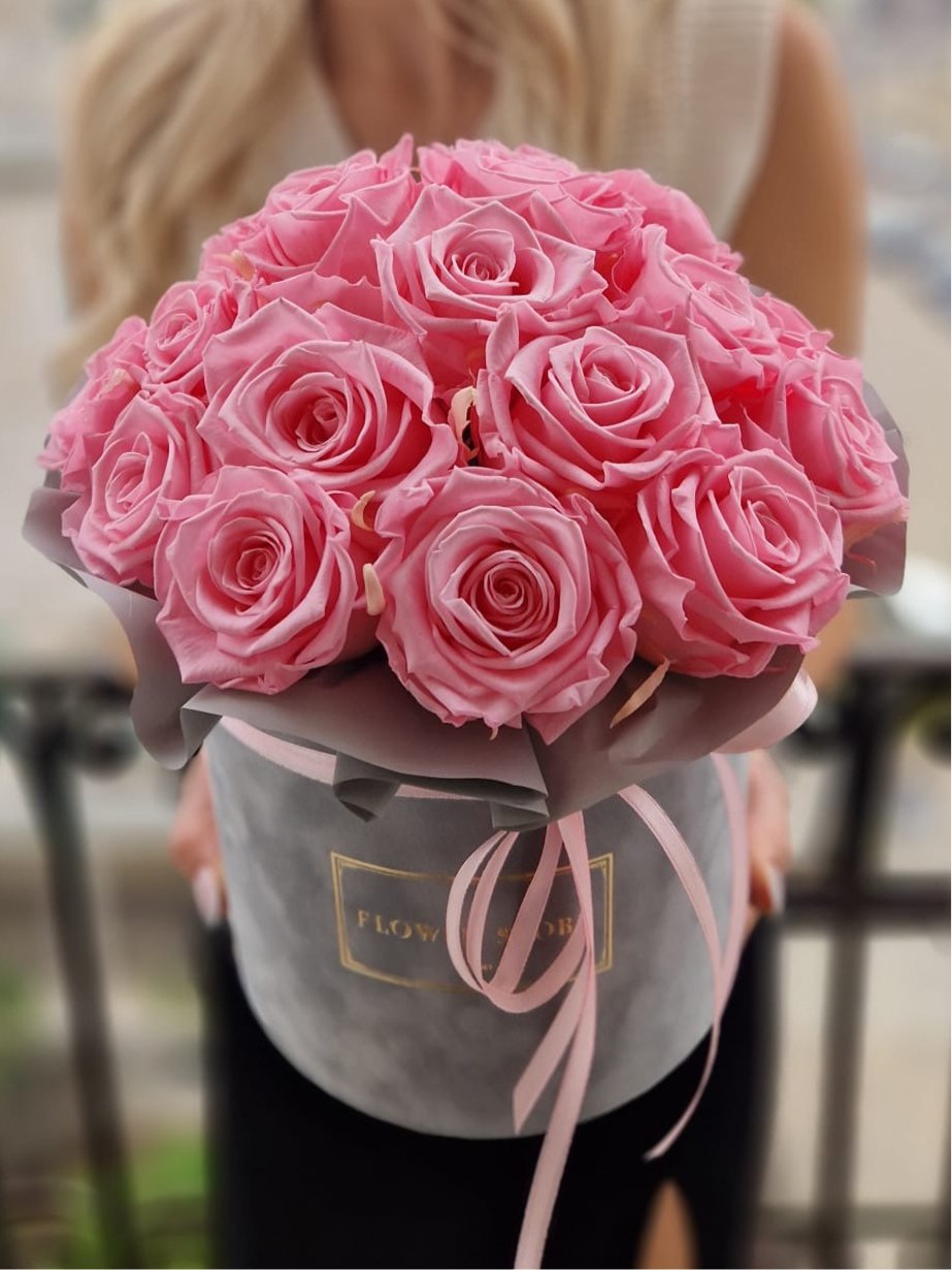 Eternal pink roses in a gray flocked box