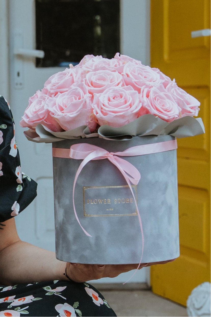 Eternal pink roses in a gray flocked box