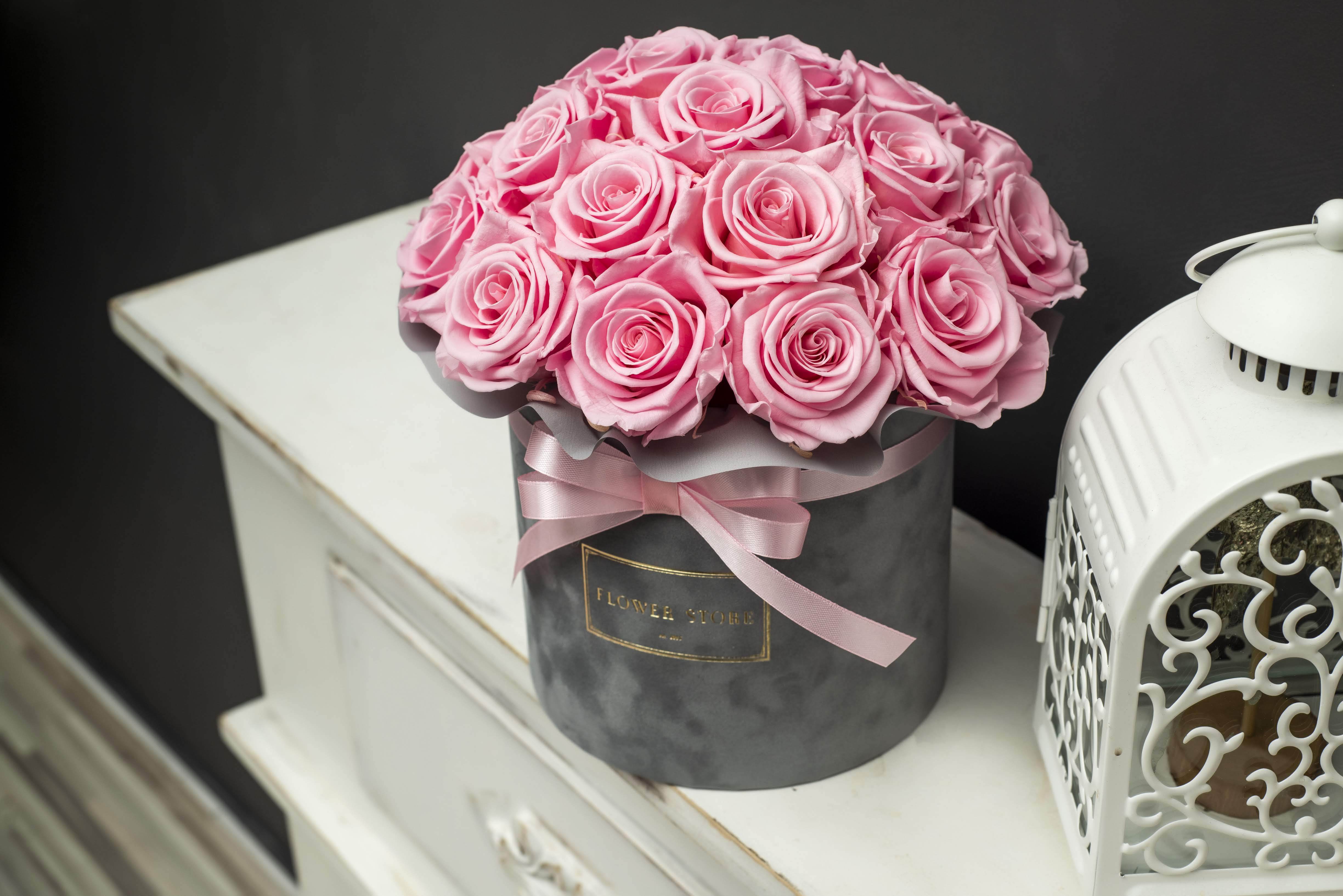 Eternal pink roses in a gray flocked box