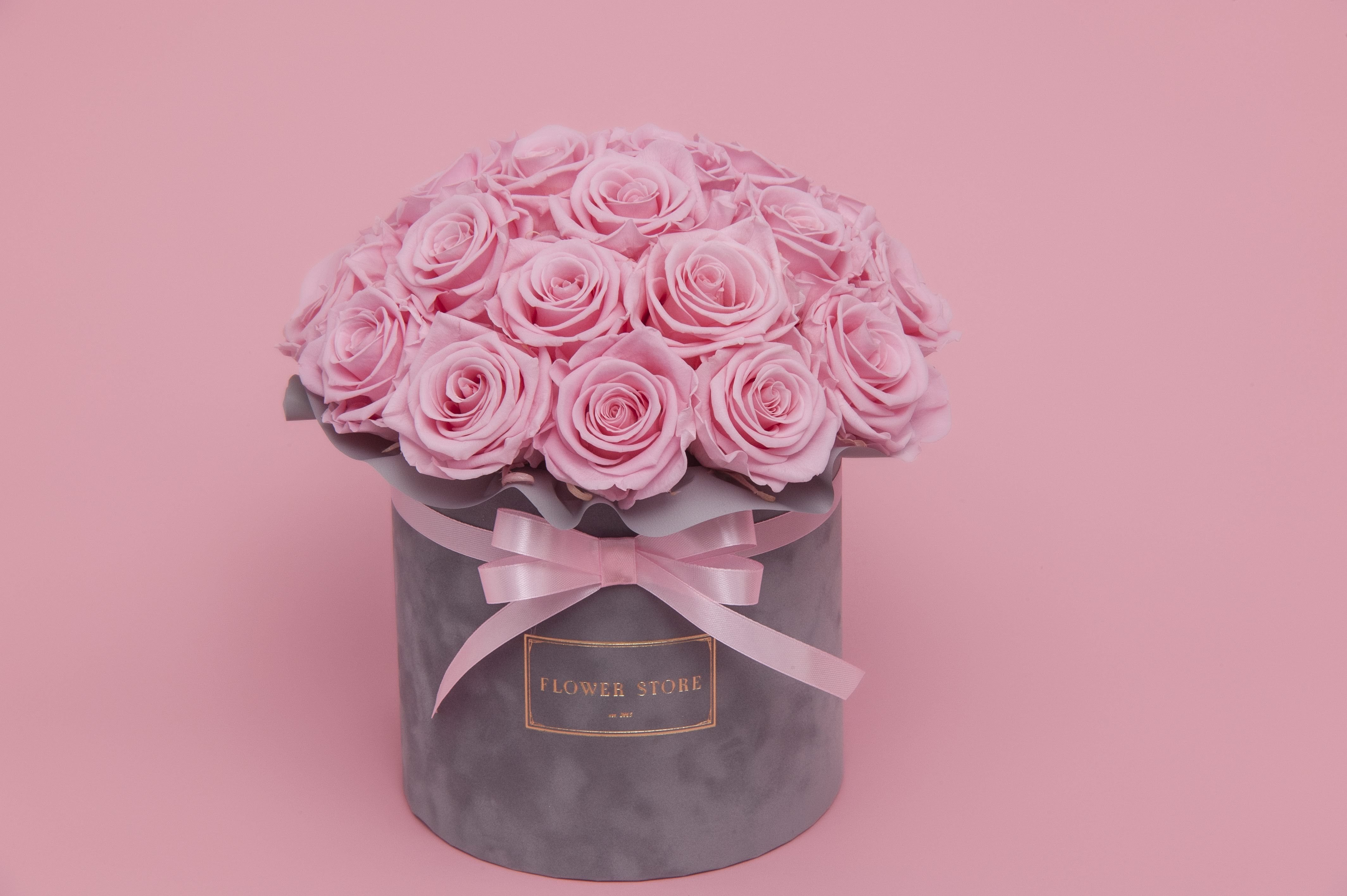 Eternal pink roses in a gray flocked box