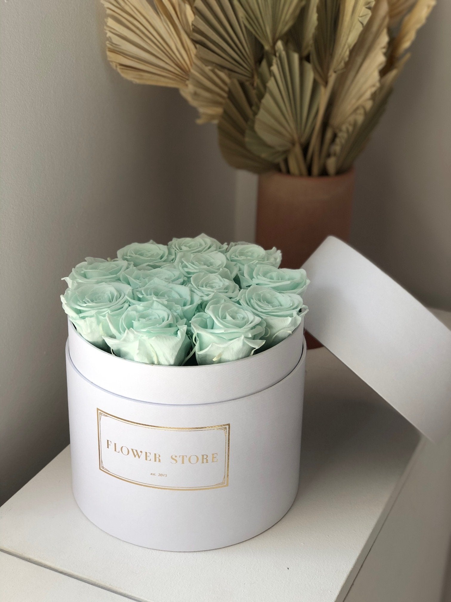 White flowerbox with mint eternal roses