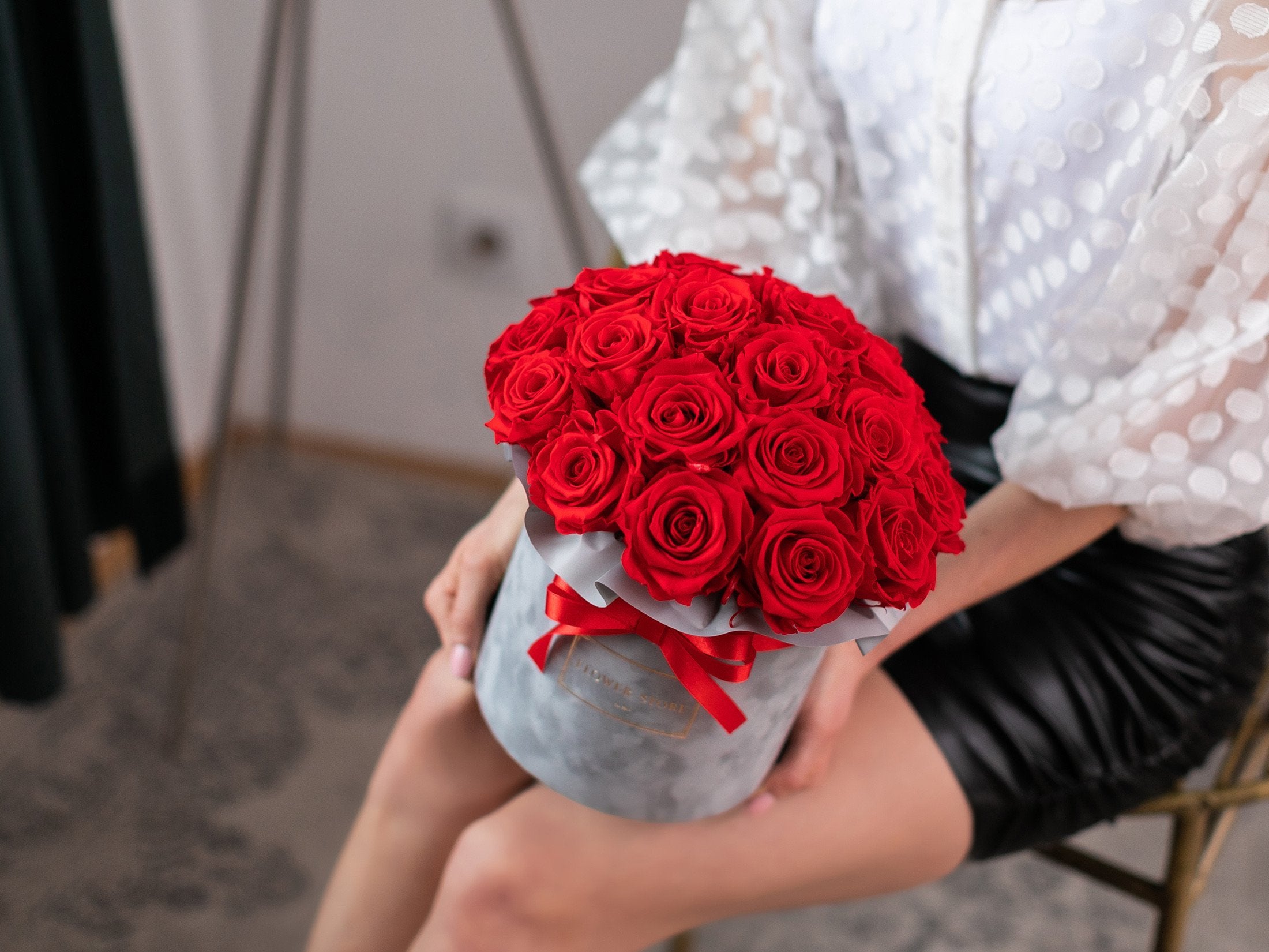 Eternal red roses in a gray flocked box