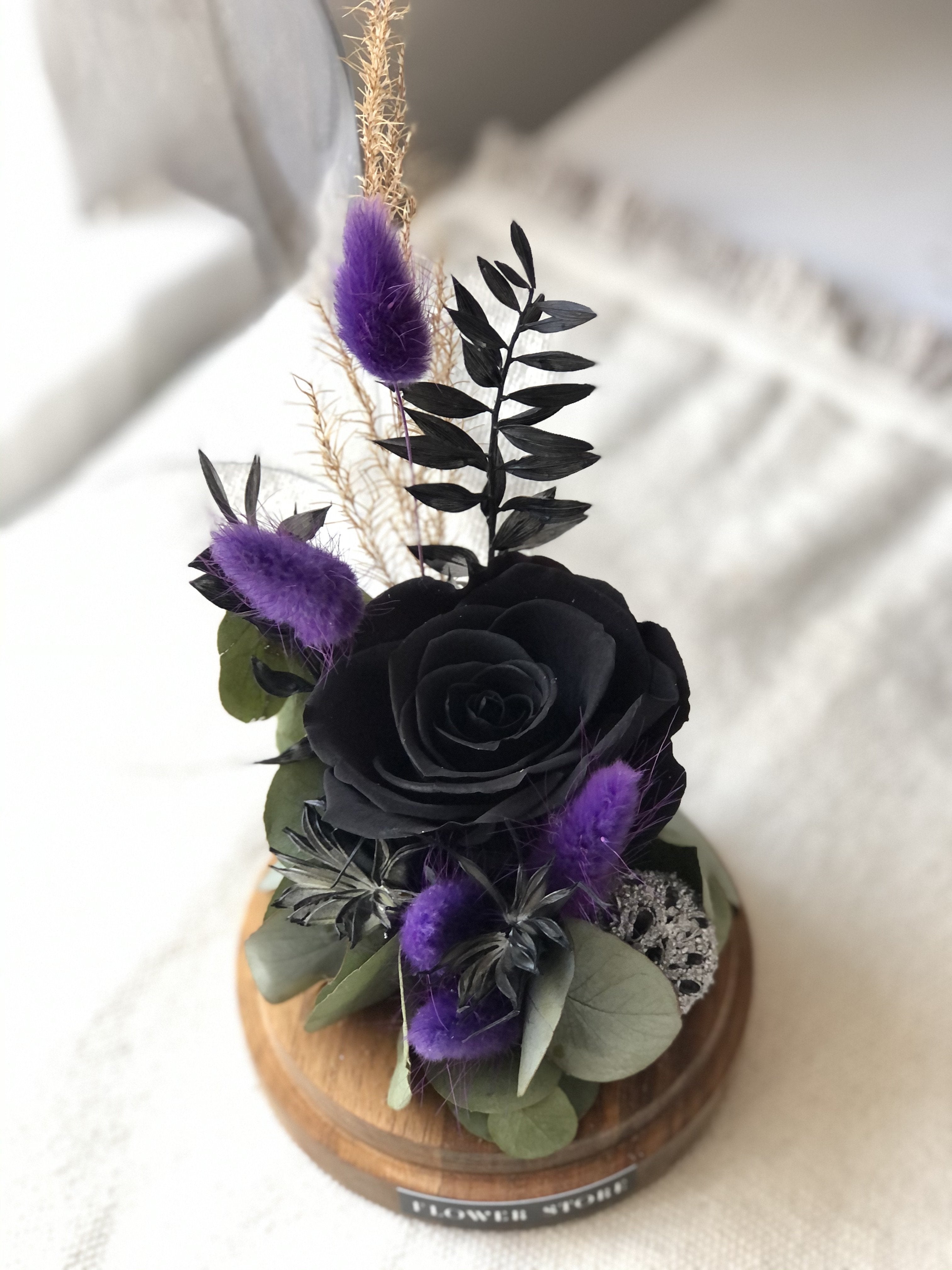 Dried composition with black eternal rose in glass