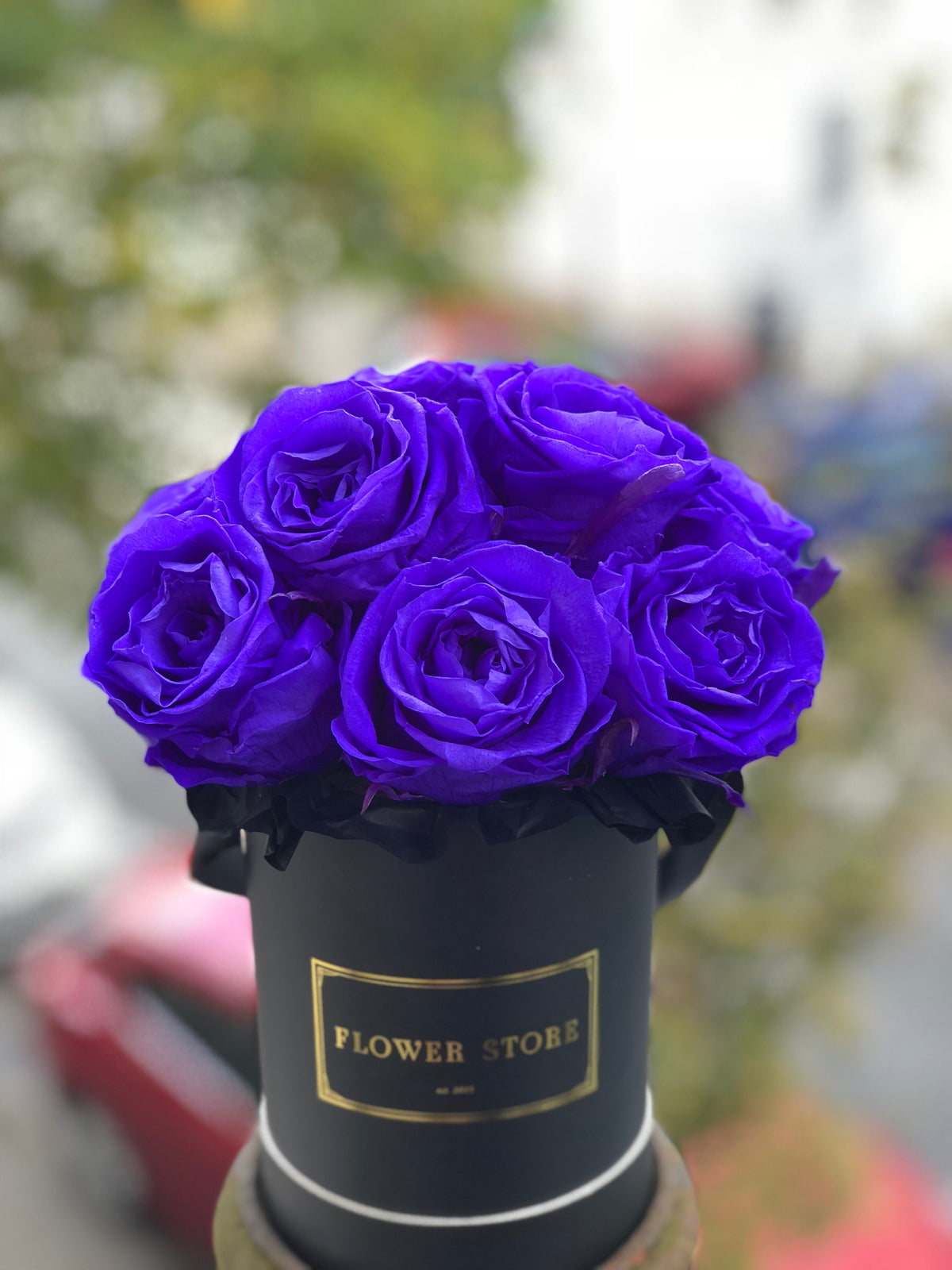 A small black box with navy blue eternal roses