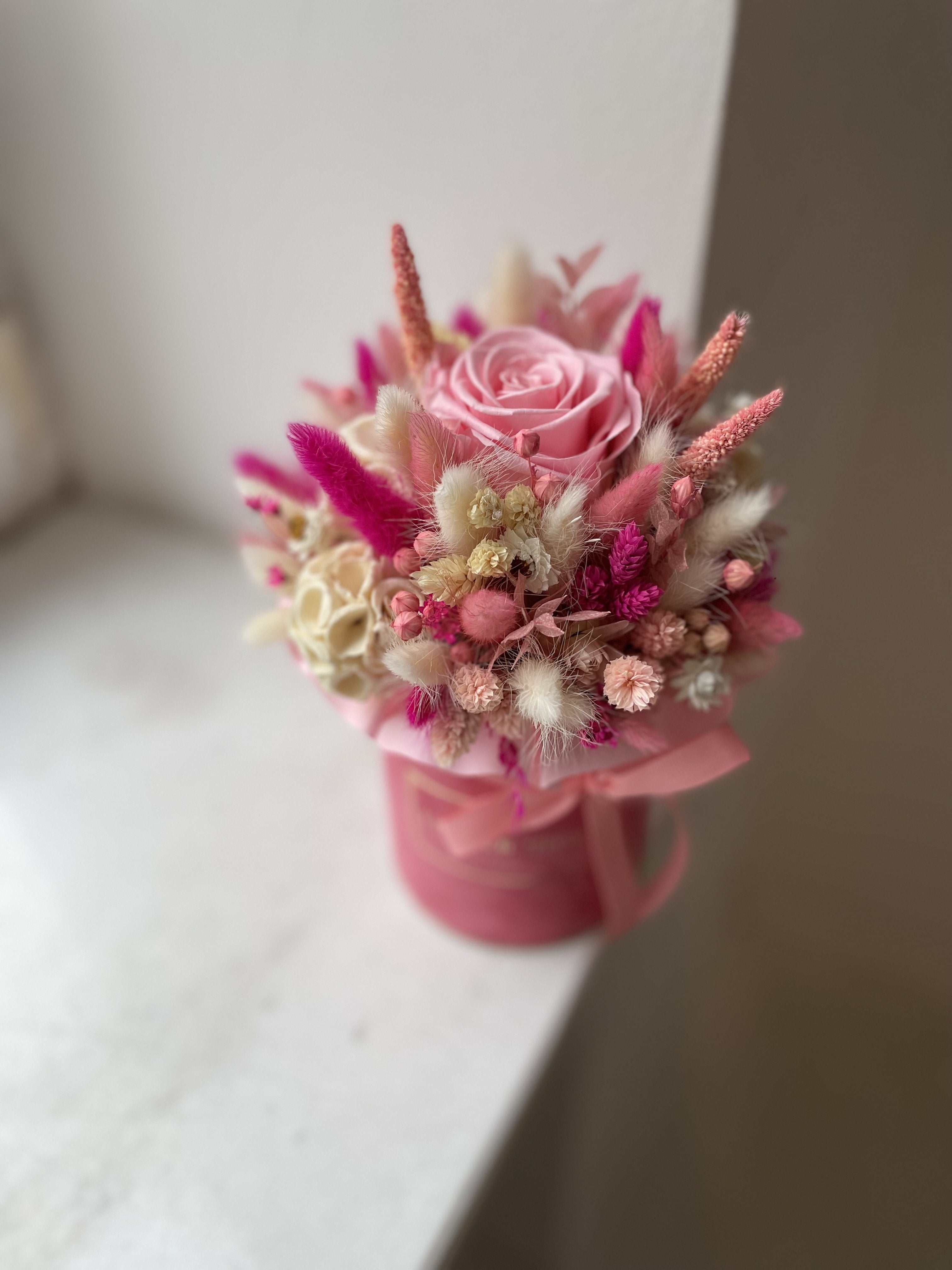 Small flocked dried flower box with a pink eternal rose