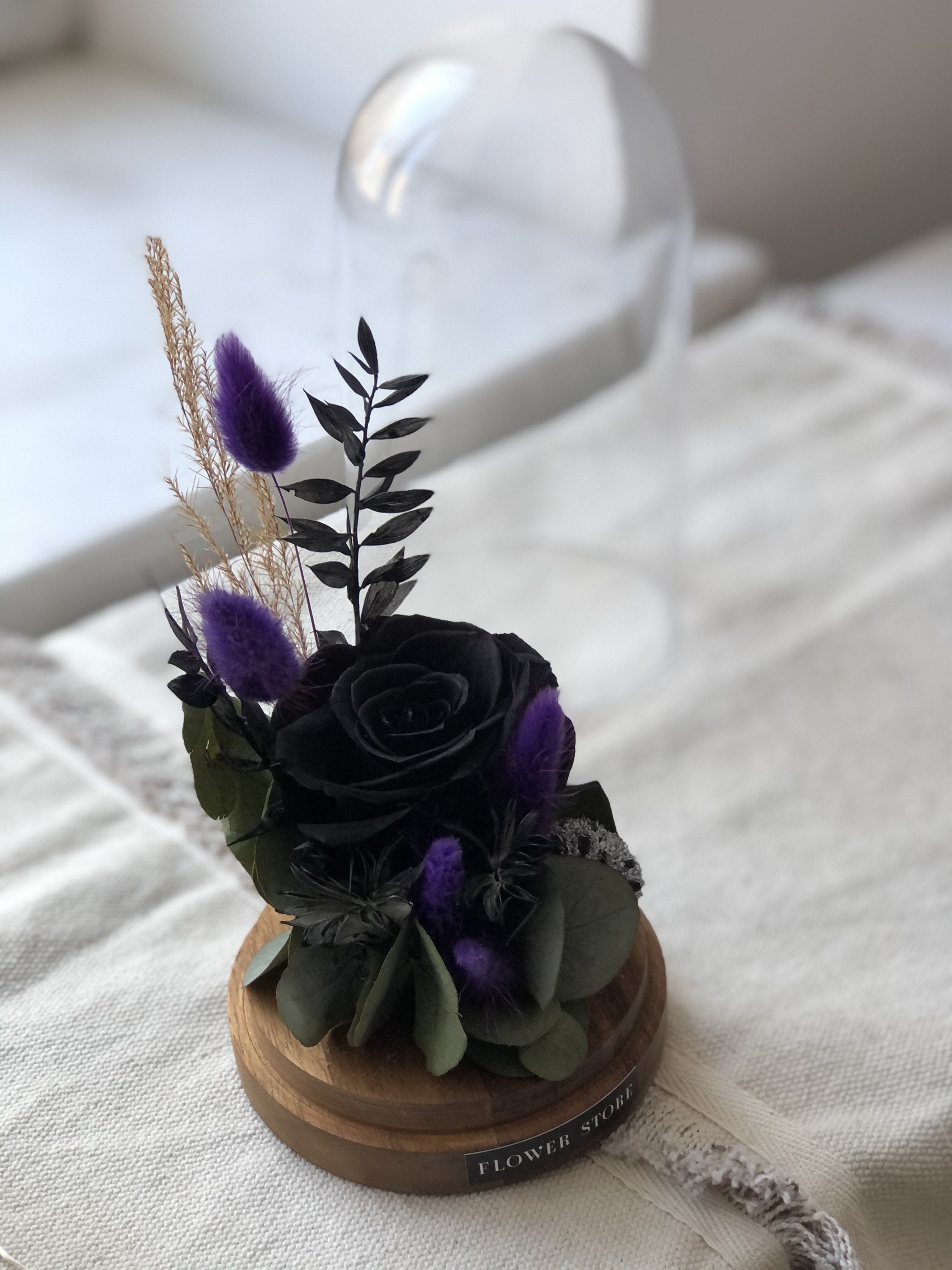 Dried composition with black eternal rose in glass