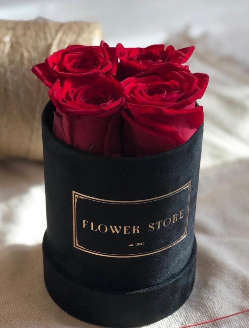 Black flocked flower box with 4 red eternal roses