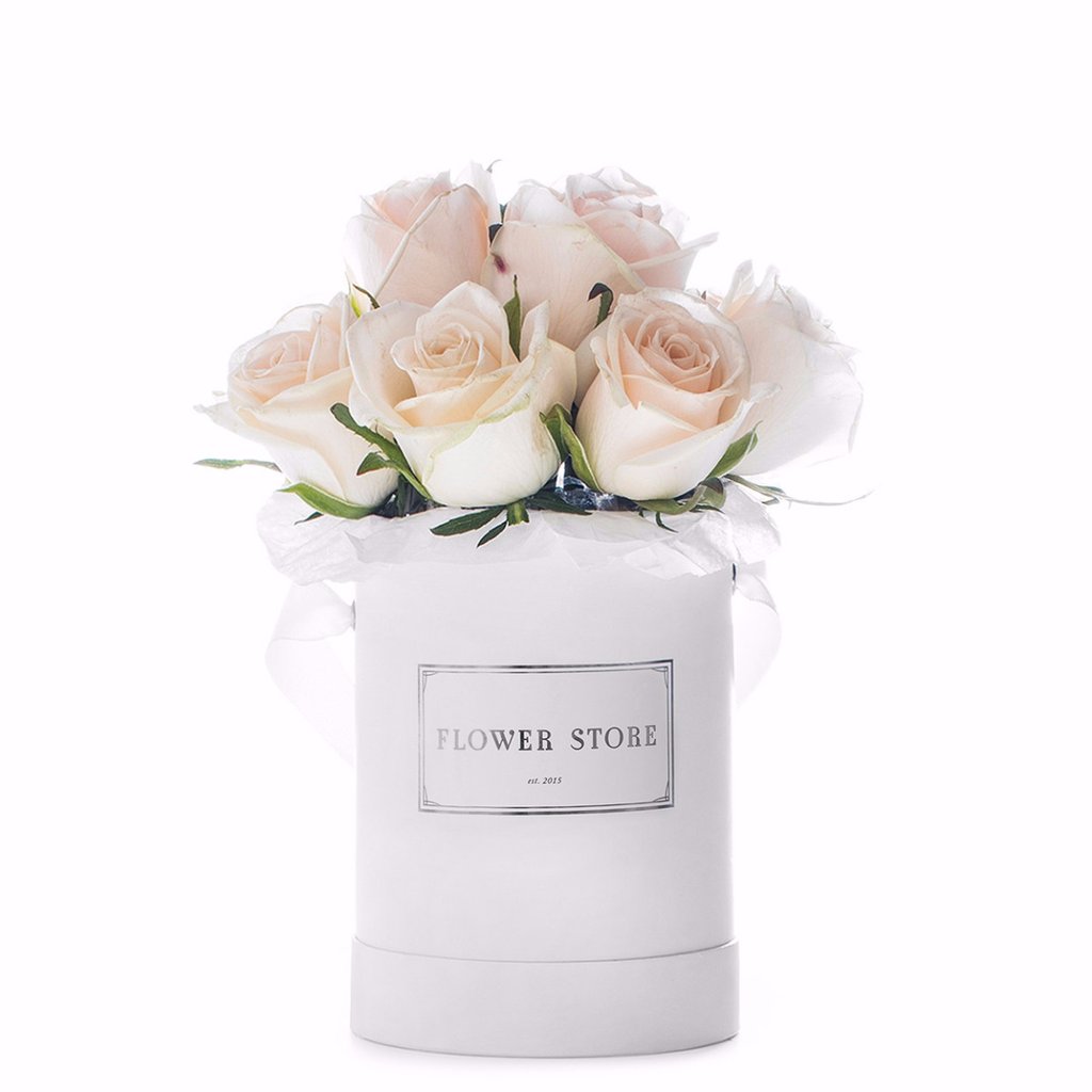 A small white box with white eternal roses