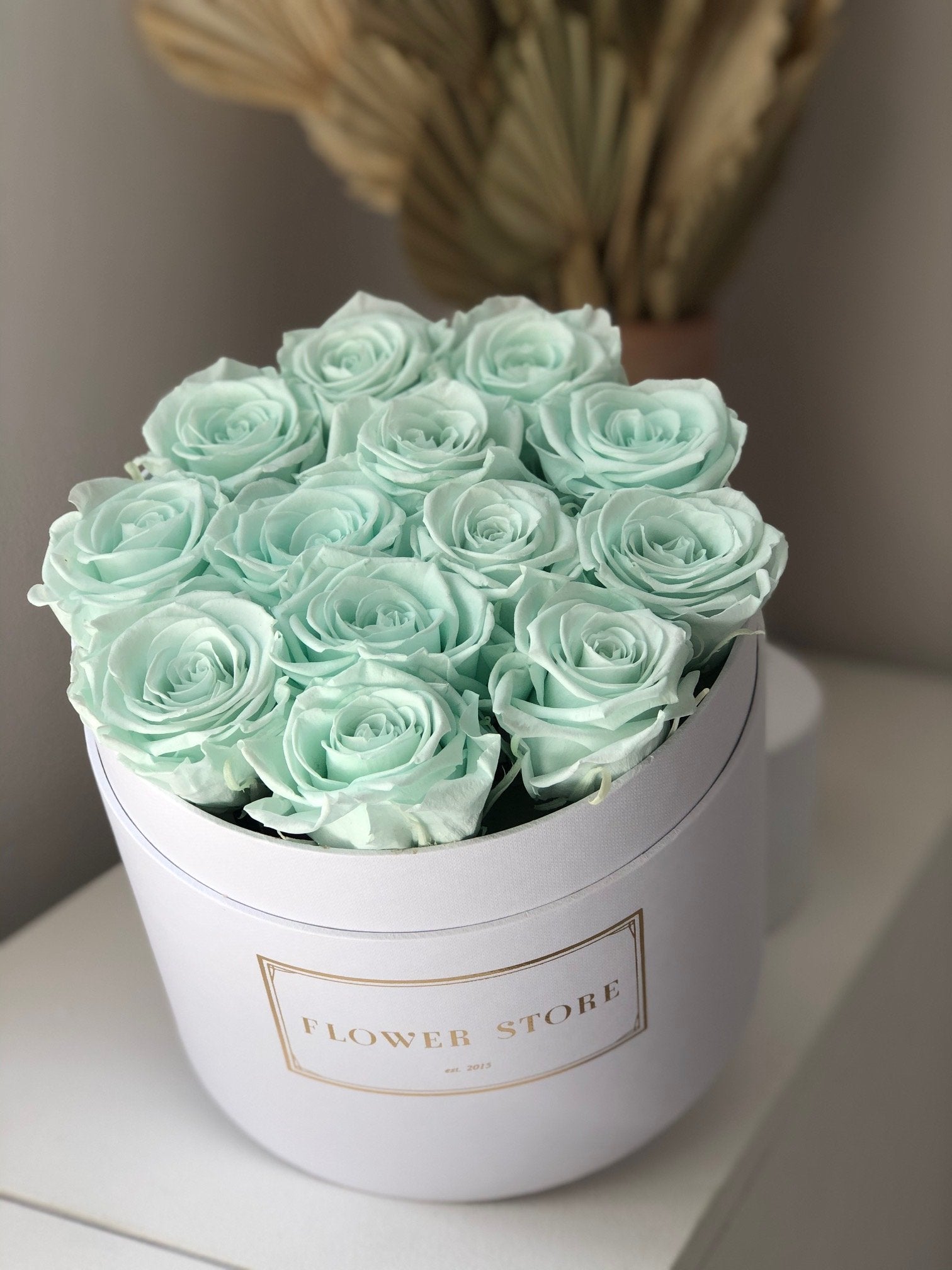White flowerbox with mint eternal roses