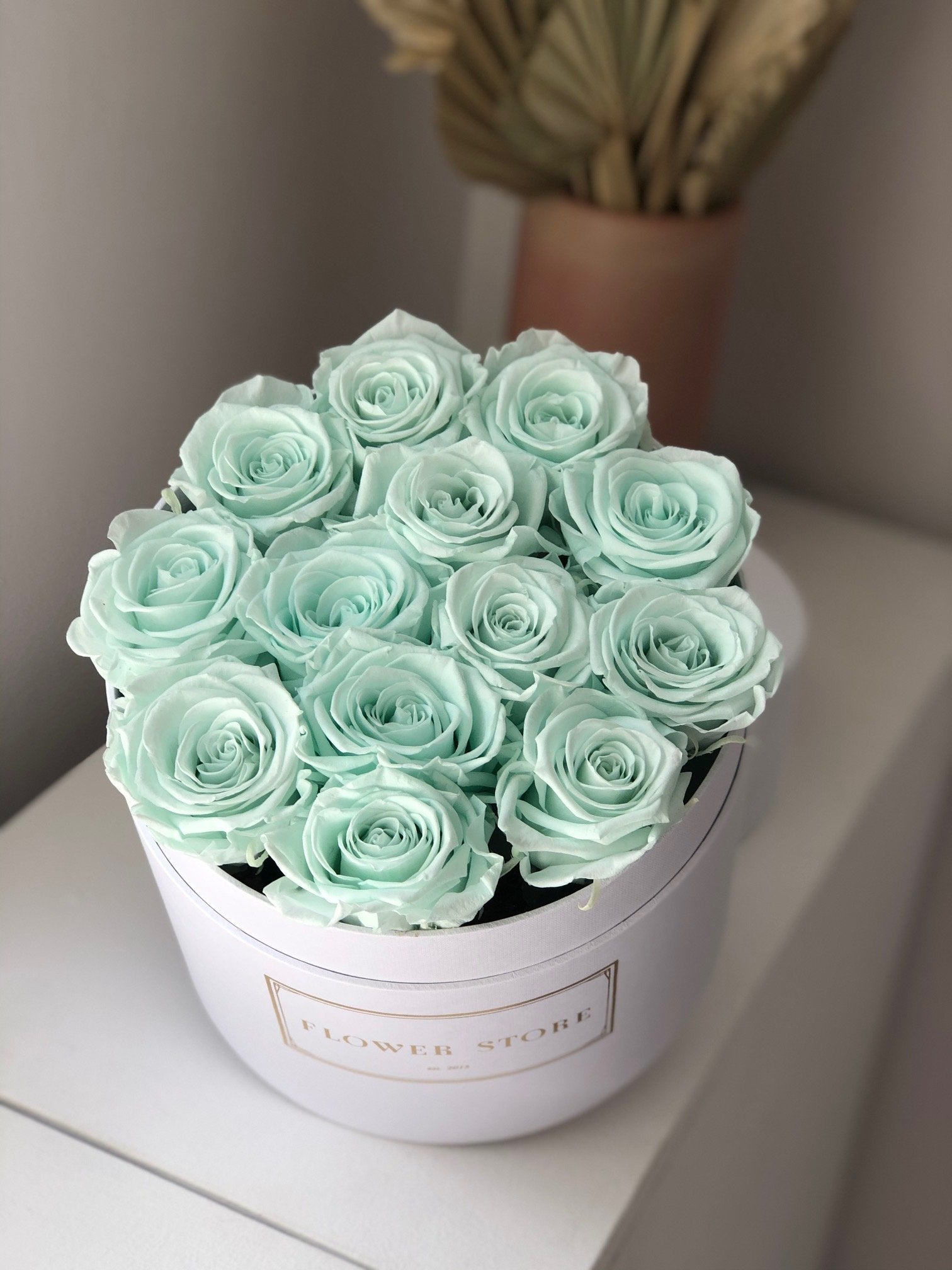 White flowerbox with mint eternal roses