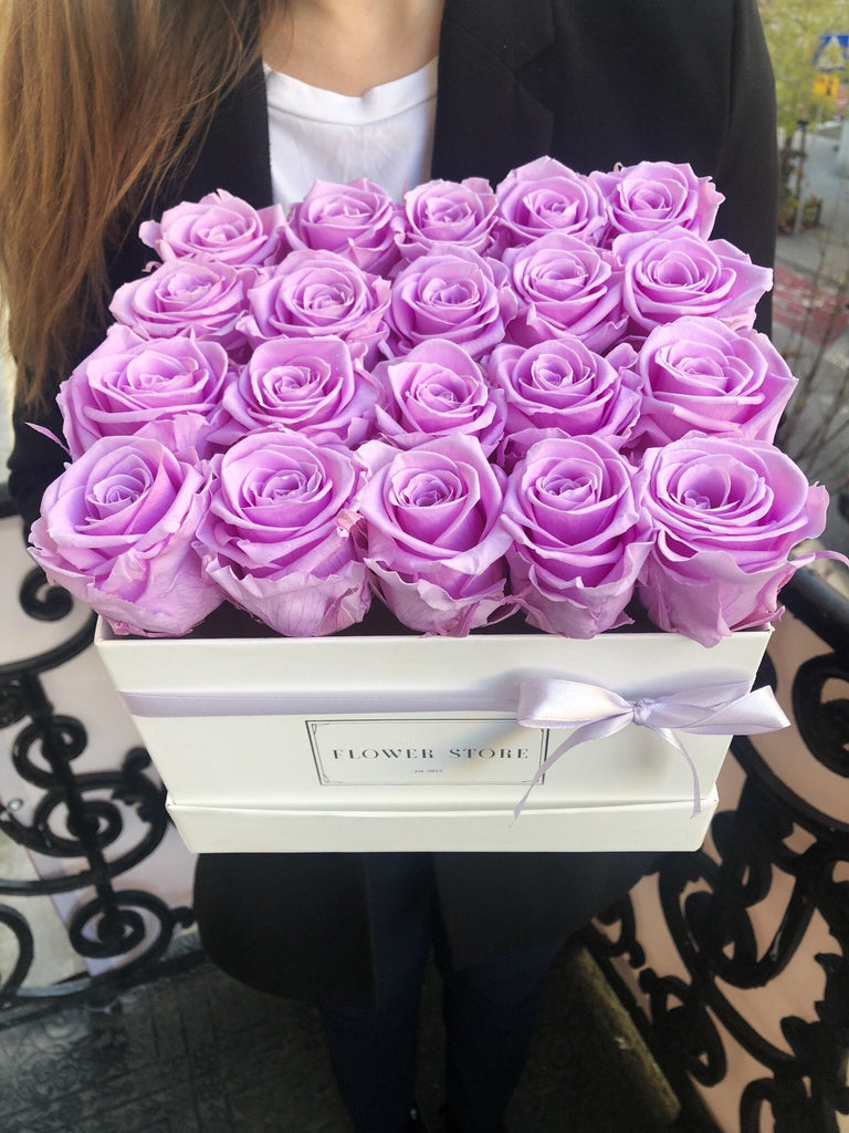 Lilac eternal roses in a white square box