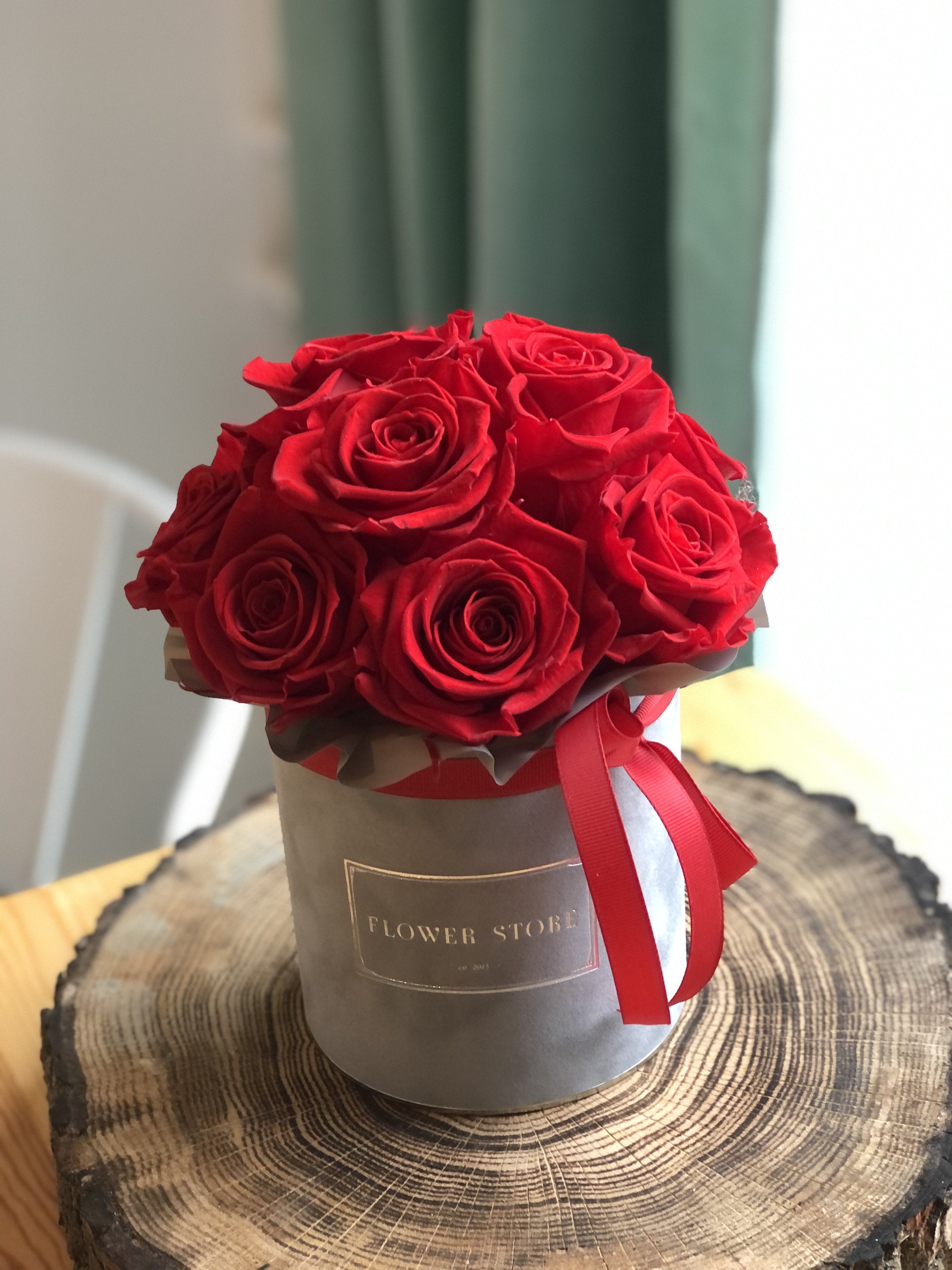 Small gray flocked flowerbox with red eternal roses